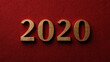 © RRIKATO - Golden 2020: The year 2020 is displayed in a elegant gold hue against a deep red textured backdrop, symbolizing the beginning of a new decade.