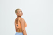 © Bliss - Young woman showcases bold style in sporty attire within a vibrant studio setting