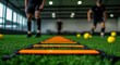 © dreamer - Athletic Training Session with Focus on Footwork Drills Using Agility Ladder on Indoor Turf Surface in Modern Training Facility