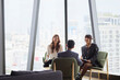 © Johnér - Smiling businesswomen communicating with male manager in team meeting at office