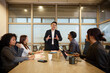 © Johnér - Manager discussing marketing skills with team sitting around table in meeting room