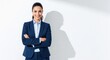 © Soklin - A confident businesswoman in a blue suit, standing with her arms crossed, against a plain white background.