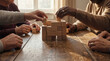 © Artem Zatsepilin - african and caucasian senior hands building wooden block tower on table. teamwork and collaboration concept. activity for elderly. healthcare brochure, social media post.