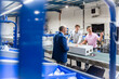 © Westend61 - Team meeting in production hall discussing manufacturing process