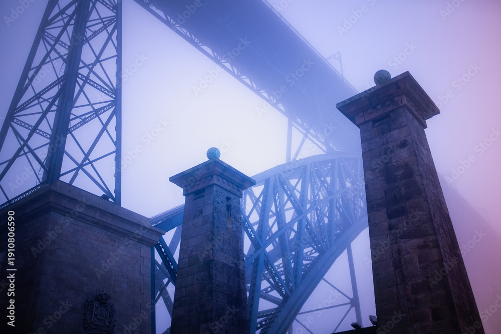 Stock-Foto „Dom Luis I Bridge in Porto rising above stone pillars in ...