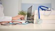 © DawDunia - Doctor working at medical office desk, with stethoscope resting on medical textbooks and glasses on a clipboard, representing healthcare learning and professional consultation