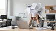 © Abdul - A stressed businesswoman overwhelmed with paperwork at her office desk