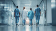 © Lita Clarus - Medical Team Walking Through Hospital Corridor
