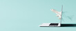 © hd3dsh - Online plane tickets. Airplane passes through the laptop screen on blue background. 3D Rendering, 3D Illustration