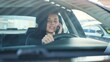 © Vlad - Happy young lady holding smartphone and talking in car. Slow motion