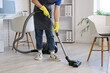 © Pixel-Shot - Male janitor with modern vacuum cleaner cleaning floor in office