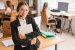 © Pixel-Shot - Female Asian technical support agent with headset and laptop in office