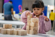 © geargodz - preschool child girl concentrating on building tower with wooden block
