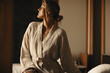 © Jacob Lund - Woman in bathrobe enjoying relaxation and comfort in a tranquil setting