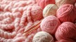 © StasySin - A bunch of yarn and knitting needles on a pink background. The yarn is pink and white and the needles are silver