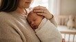 © Zlfhr - Heartwarming close-up portrait of a new mother tenderly holding her peaceful newborn baby wrapped in a soft blanket, celebrating maternal love and the calm innocence of infancy