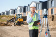 © Serhii - Engineer talking on walkie talkie at construction site