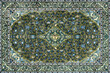 © TMR Studio - Close up of classic middle eastern Persian rug texture. Engraving and floral ornamental swirls pattern in random green and blue color. For moslem prayer mat and decorative rug. Arab middle east vibe.