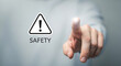 © MdSumon - Safety warning sign being touched by a hand