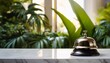 © Colton - the service bell on a marble reception counter with tropical plants in background