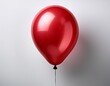 © Shannon - a single vibrant red balloon with a glossy surface and highlight reflection tethered by a thin black string against a plain white background symbolizing simplicity and joy