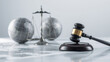 © siraphol - Gavel on wooden block with scales and global globe representing international law and justice
