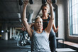© BuyoutReese09/peopleimages.com - Personal trainer, support and women in studio, fitness for health benefits and dumbbells. People, instructor or exercise in gym, equipment or motivation for workout technique, help and training
