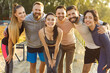 © Studio Romantic - Happy runners standing in group, smiling after sport workout. Portrait of diverse people hugging in summer park, cheerful athletes showing teamwork, energy and team spirit of healthy fitness community