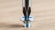 © Suginen - Close-up of screwdriver driving metal screw into wooden surface precisely