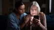 © SerPak - A concerned woman comforts her elderly mother while she struggles to use a smartphone. Emotional support and technology assistance.