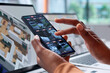 © Andrey Popov - Security Specialist Monitoring Surveillance Cameras On Smartphone