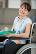 © auremar - young adult woman on wheelchair smiling