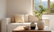 © simba kim - living room with pottery on table, two jars, one bowl with plant, cream couch