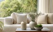© simba kim - living room with pottery on table, two jars, one bowl with plant, cream couch