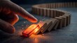 © AiStock B - Hand pushes glowing start domino, sparking reaction