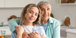 © Pixel-Shot - Senior woman hugging her granddaughter in kitchen