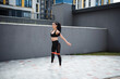 © Cavan Images - Fitness brunette woman in black leggings training outdoor
