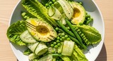 Fresh salad with avocado, peas, asparagus, and hard-boiled egg on a white plate. warzywa zielone