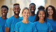 © Maryna - Diverse group of smiling people wear matching blue t-shirts for community work. Friends, colleagues unite, sharing joy in charitable activity together. People show solidarity, teamwork, contributing