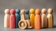 © Sweetie Pie - High quality image of diverse group of wooden figures with one in a wheelchair for inclusion concept.