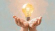 © Camalia MN - Lightbulb floating over hands, soft pastel background