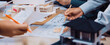 © InfiniteFlow - A dynamic scene capturing professionals engaged in an architecture design session, showcasing models, blueprints, and hands collaborating in a modern workspace. SACTR