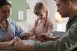 © New Africa - Family with Bible praying together at wooden table indoors