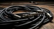 © Ima - Coiled black audio cable with connectors.