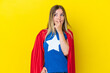 © luismolinero - Super Hero Romanian woman isolated on yellow background having doubts and with confuse face expression