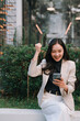 © Tj - Asian businesswoman celebrating success looking at smartphone