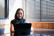 © Tj - Young Asian woman working remotely with digital tablet
