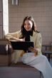 © Tj - Woman freelancer smiling working with tablet technology