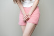 © Pormezz - woman having painful lower stomach and hands holding pressing her crotch lower abdomen