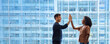 © insta_photos - Happy diverse business team man and woman giving high five at work in office. Two partners employees celebrating professional corporate success leadership financial work achievement in office. Banner